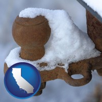 california a rusty, snow-covered trailer hitch