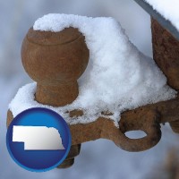 nebraska map icon and a rusty, snow-covered trailer hitch
