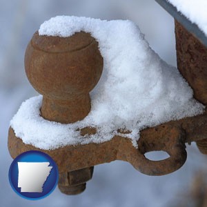 a rusty, snow-covered trailer hitch - with Arkansas icon