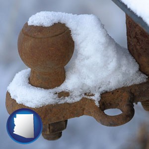 a rusty, snow-covered trailer hitch - with Arizona icon