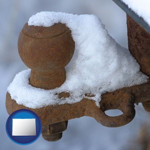 a rusty, snow-covered trailer hitch - with Colorado icon