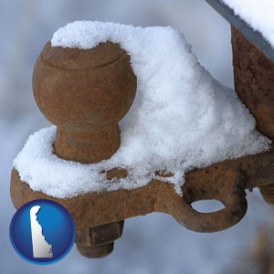 a rusty, snow-covered trailer hitch - with Delaware icon