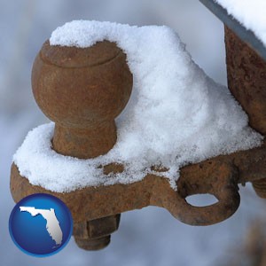 a rusty, snow-covered trailer hitch - with Florida icon