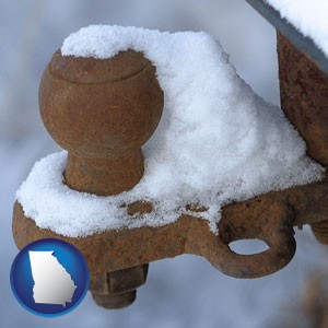 a rusty, snow-covered trailer hitch - with Georgia icon