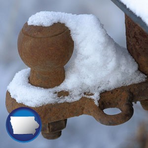 a rusty, snow-covered trailer hitch - with Iowa icon