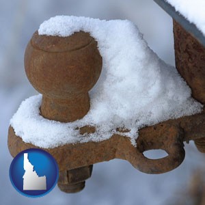 a rusty, snow-covered trailer hitch - with Idaho icon
