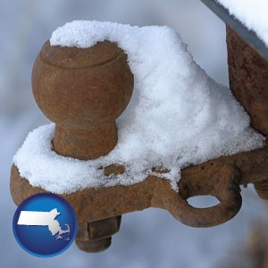 a rusty, snow-covered trailer hitch - with Massachusetts icon