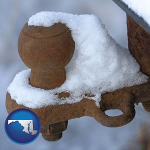 a rusty, snow-covered trailer hitch - with Maryland icon