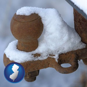 a rusty, snow-covered trailer hitch - with New Jersey icon