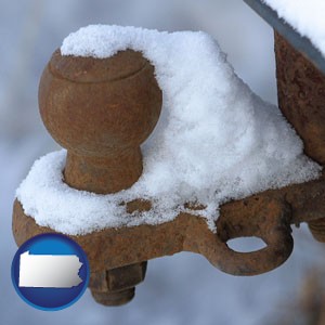 a rusty, snow-covered trailer hitch - with Pennsylvania icon