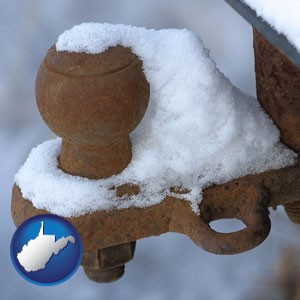 a rusty, snow-covered trailer hitch - with West Virginia icon